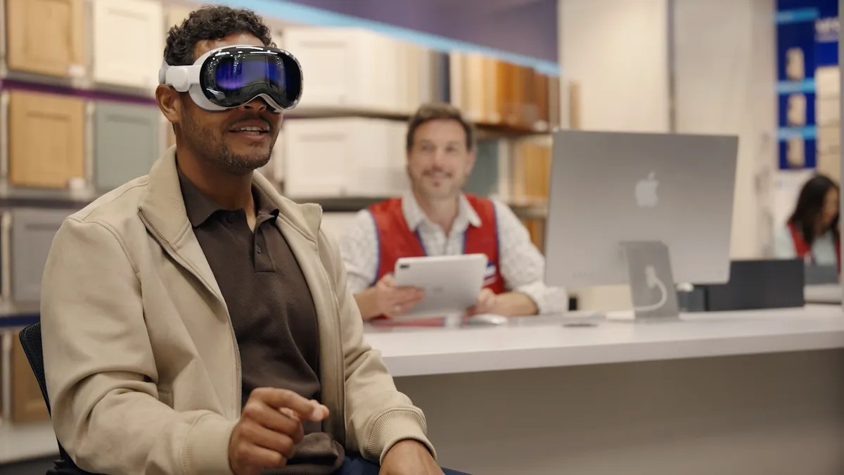 Person wearing Apple Vision headset sitting in a chair.