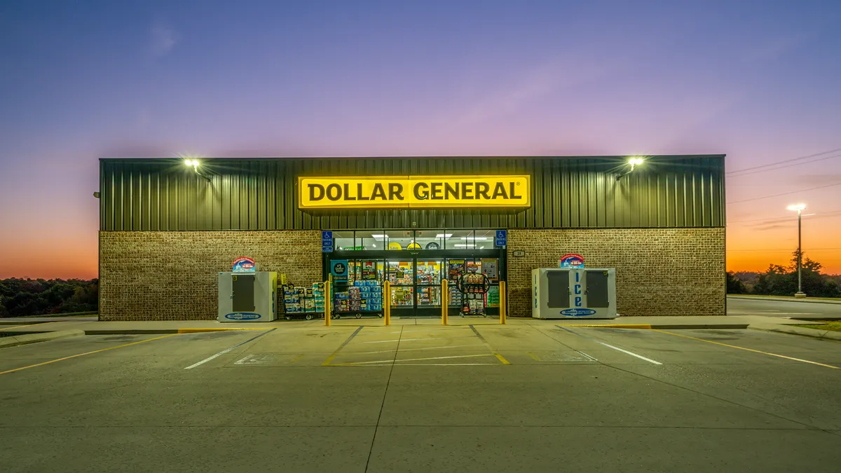 A Dollar General storefront at dawn or dusk with an empty parking lot