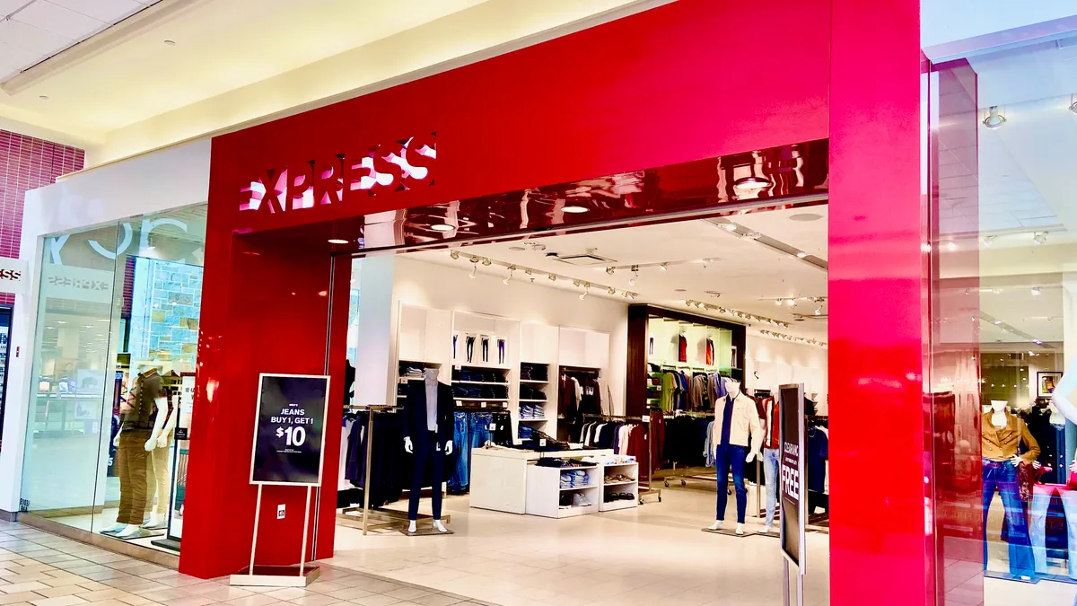 A bright-red mall entrance to a clothing store.