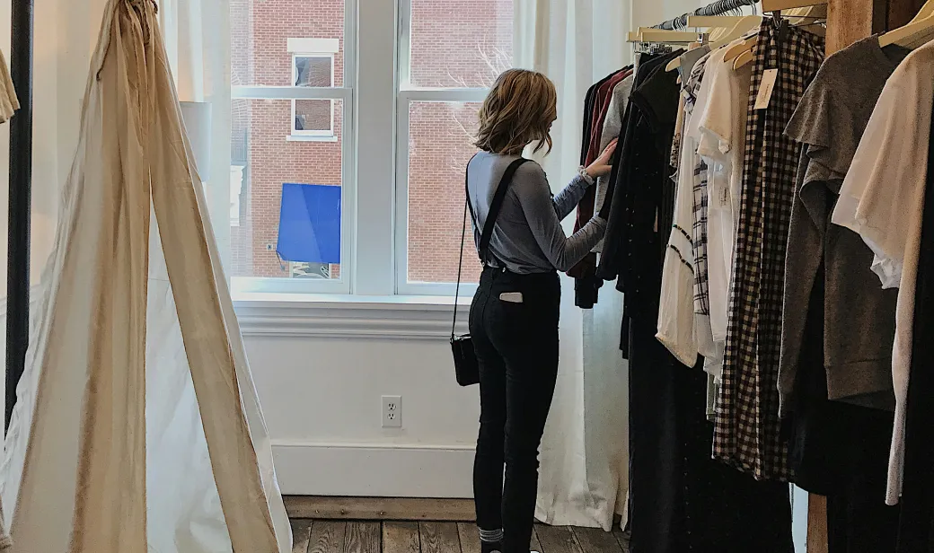 Woman looking at clothing options in store