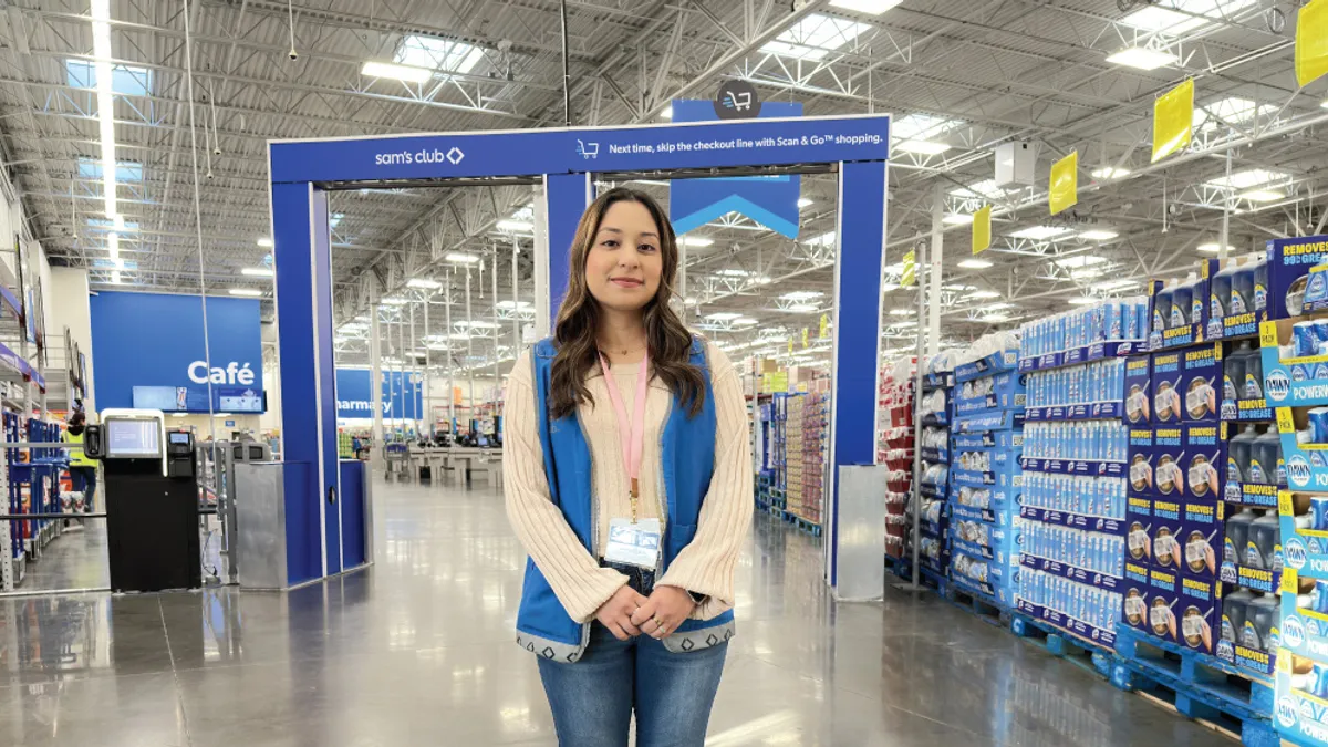 A person in front of shopping cart scanners in a store